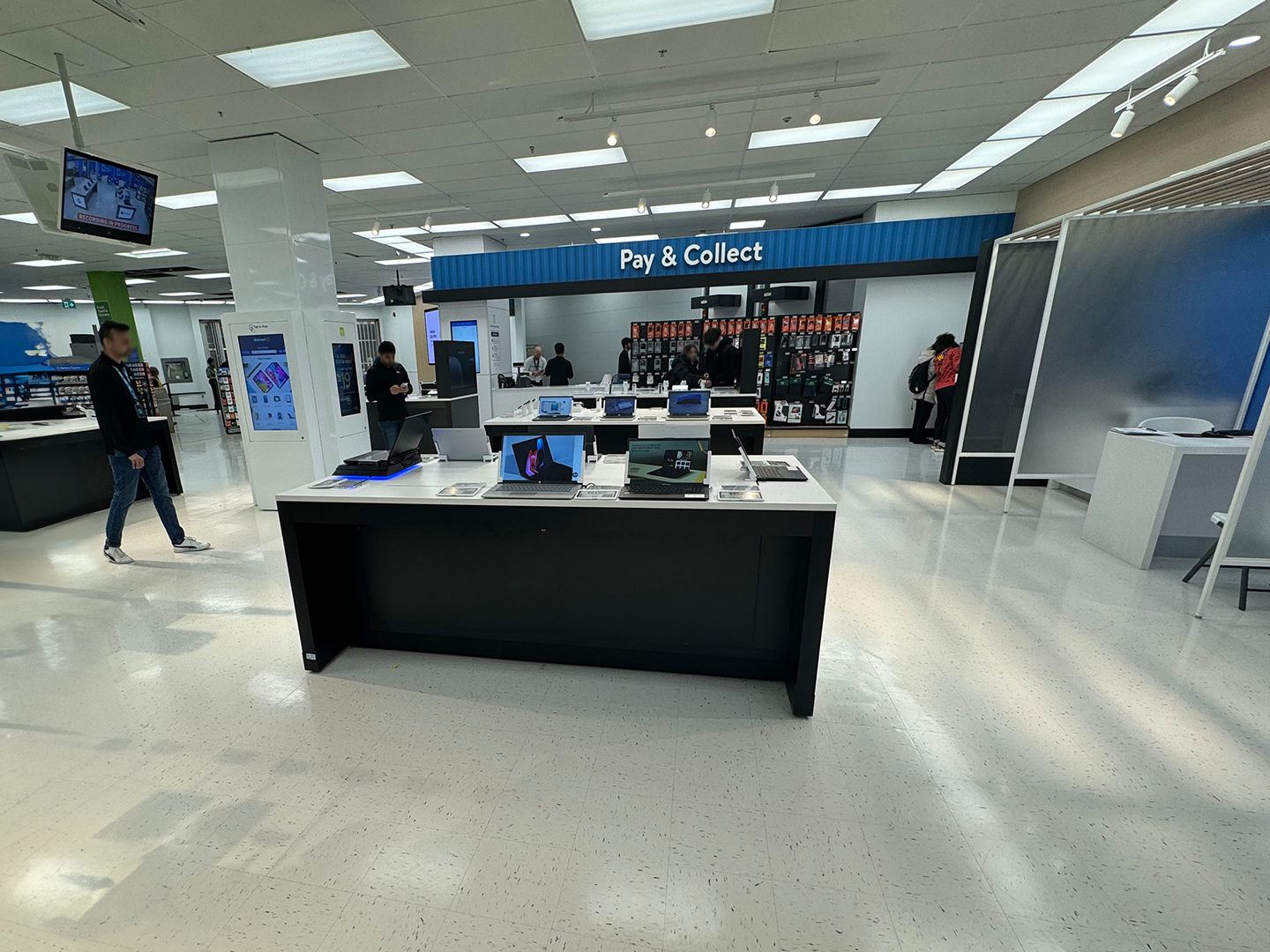 Front view of electronic department displays at Walmart with a sleek counter and various products
