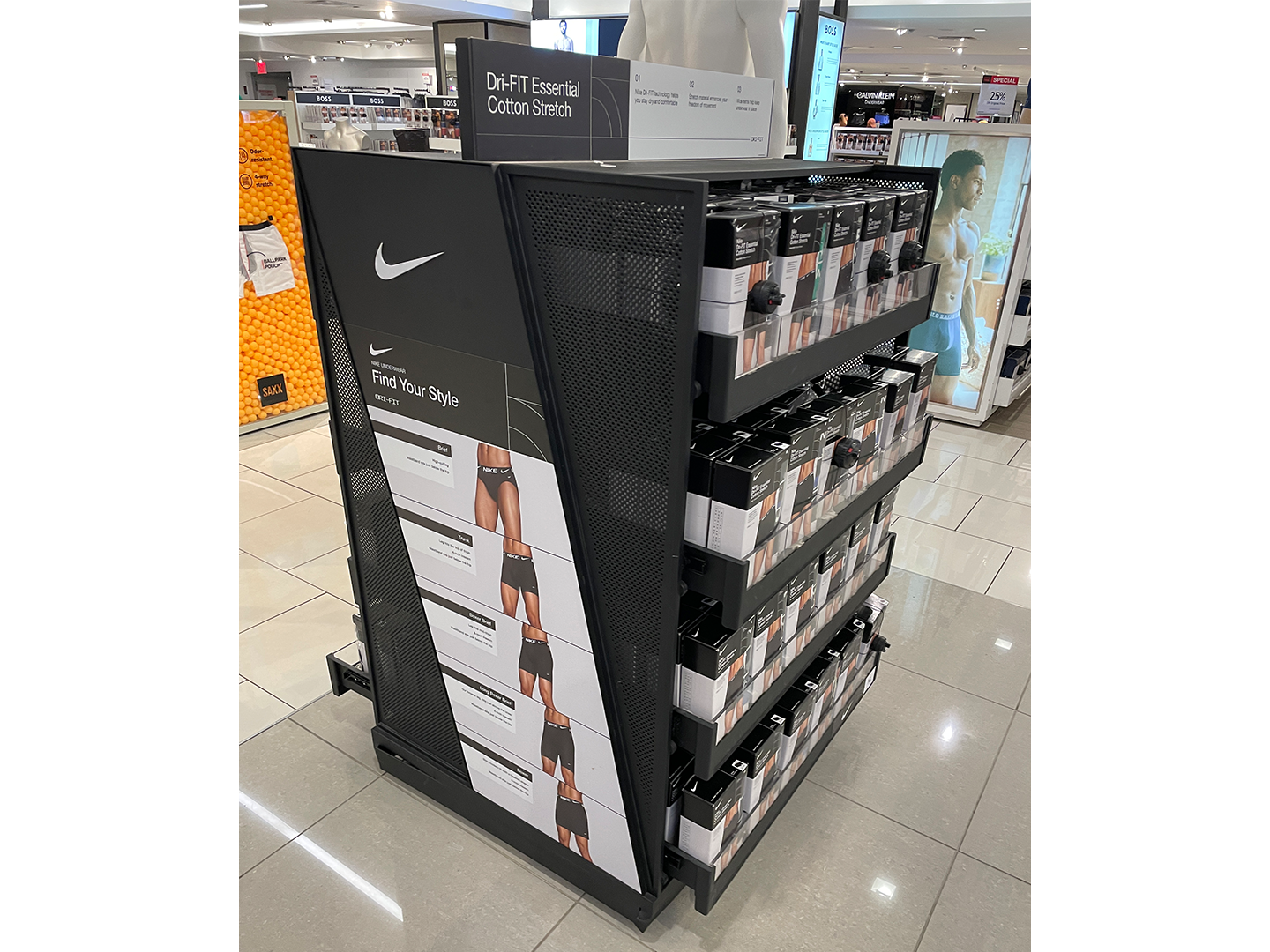 Custom-designed underwear display with side shelving and side-mounted signage